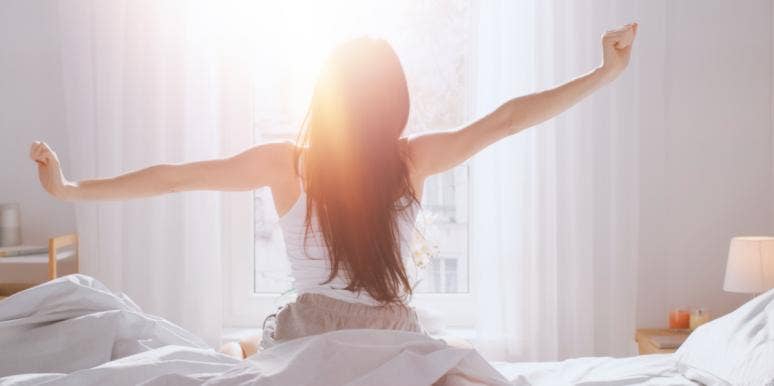Why Women Need More Sleep Than Men woman stretching morning waking up