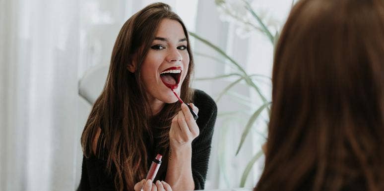 45% Of Men Think Makeup Is A Major Turn-Off woman putting on red lipstick