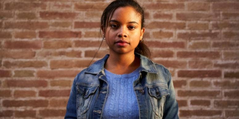 How I Use Hurtful Words As Fuel To Become A Better Person girl on brick wall