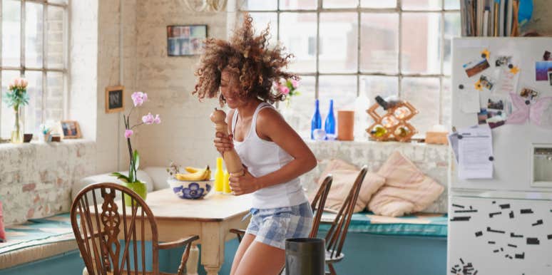 To All The Women Who Are Worried About Fitting In woman dancing in a kitchen in her pajamas