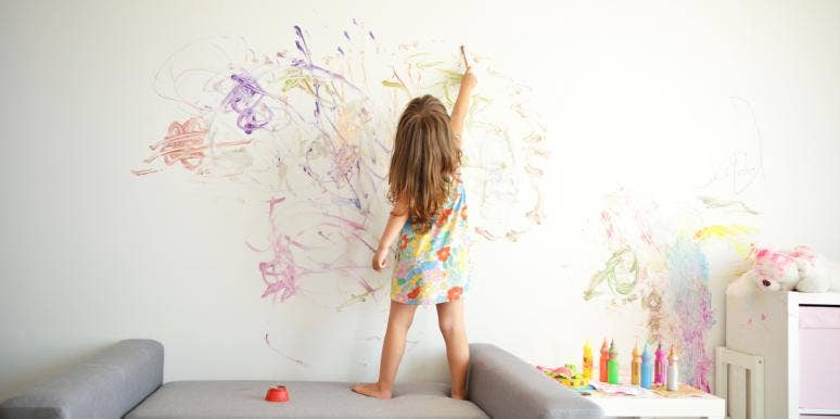 child coloring on walls