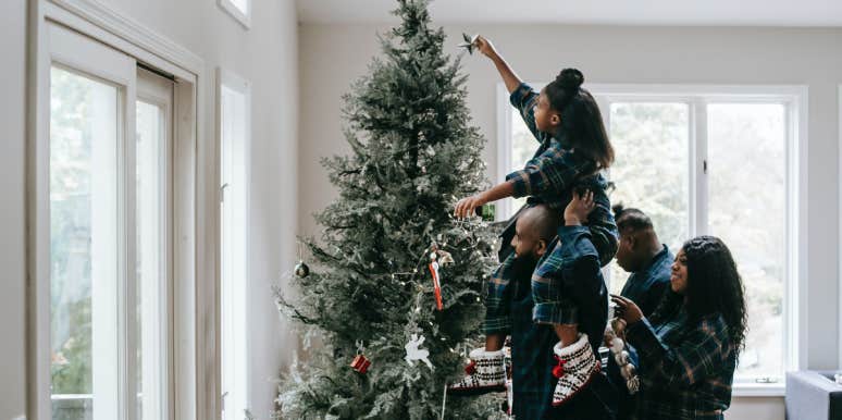 Family setting up Christmas Tree