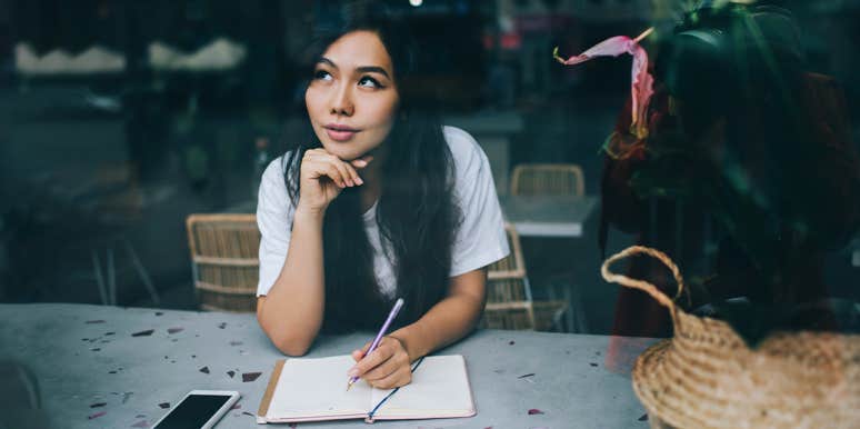 Why You Should Never Be Afraid To Share Your Story woman writing in journal