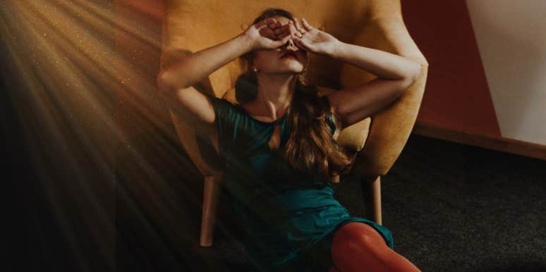 How Each Zodiac Sign Acts After A Breakup woman leaning on a chair covering her face