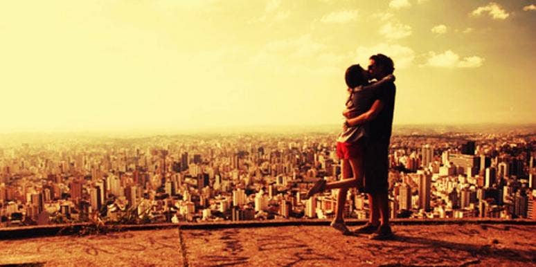 couple kissing in front of skyline couple kissing in front of skyline