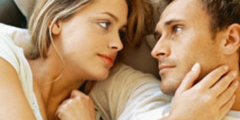 serious couple in bed