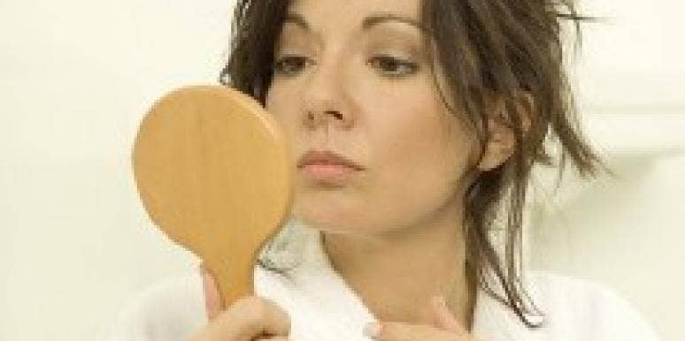 Aging, Body Image And Dating A Younger Man woman looking in a mirror