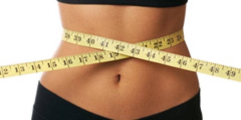 woman with a tape measure around her stomach