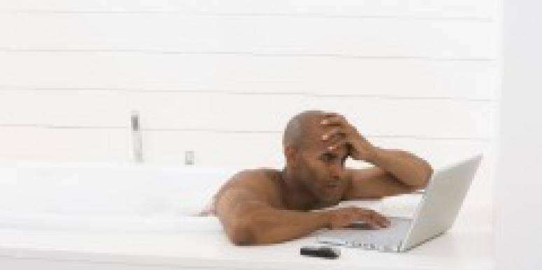 8 Things Guys Should Omit From Their Online Dating Profiles Man in bathtub with laptop