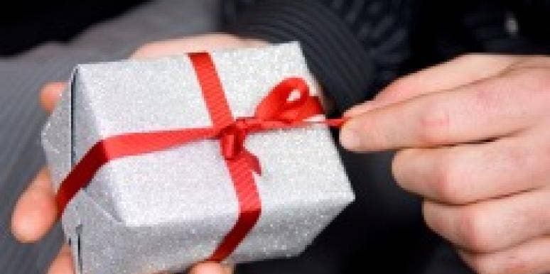 Man's hand opening a Christmas gift