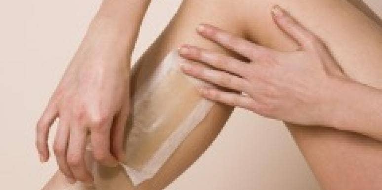 Woman waxing her leg