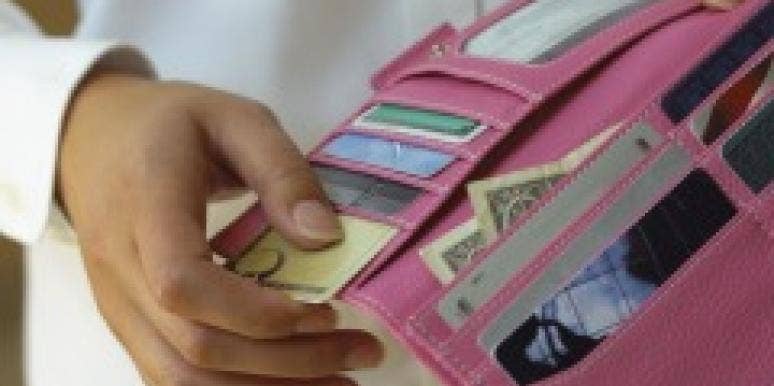 Do Female Breadwinners Need Special Relationship Rules? Woman's hand opening a wallet