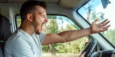 Man raging with anger behind the wheel