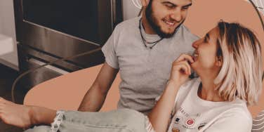 couple being silly on their kitchen floor