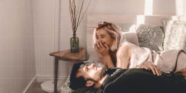 couple laughing together in bedroom