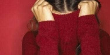 woman hiding in turtleneck