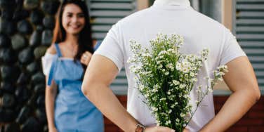 Man giving woman flowers 