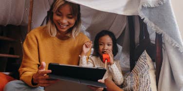 mom playing with daughter in fort
