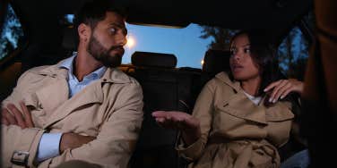 man and woman arguing in car