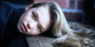 woman resting head on table