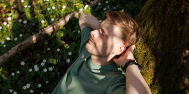 man relaxing on tree