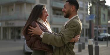 man and a woman on the street talking