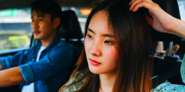 unhappy woman in car with boyfriend