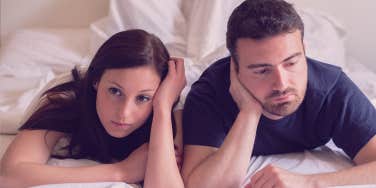 couple looks boarded on bed