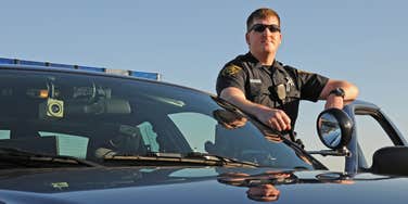 police officer standing outside squad car