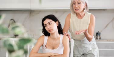 elderly woman trying to talk to angry younger woman