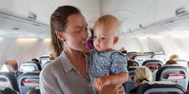 Mother and baby traveling on plane
