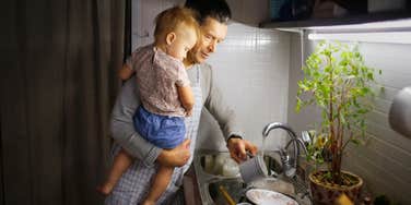 man holding son doing chores