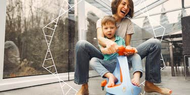 Single mother on scooter with a little boy, laughing