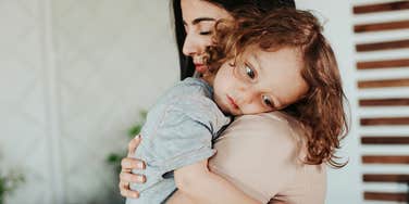 mom holding impressionable child