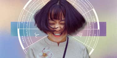 woman smiling with the best horoscope and zodiac wheel
