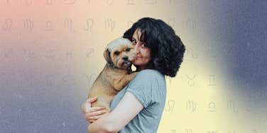 woman holding a small dog breed with zodiac signs