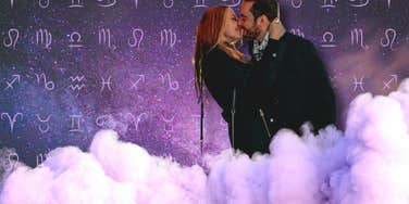 couple kissing in clouds in front of zodiac sign