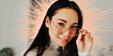 Confident woman, tipping her glasses down
