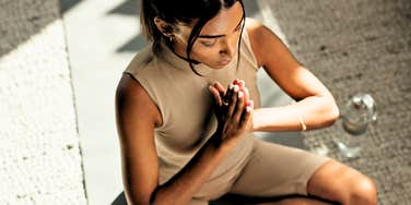Woman finding her calm, practicing seven chakras 
