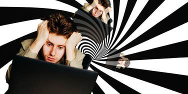 Man annoyed, going crazy staring at computer screen 