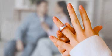 Woman takes off ring knowing the secrets for surviving divorce.