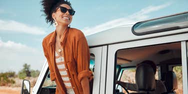 Woman having a selfish teacher summer on a road trip. 