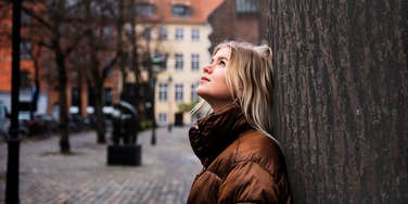 Woman looking up relieved after going no contact with her mother 