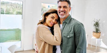 Newly married couple in their fifties at home together