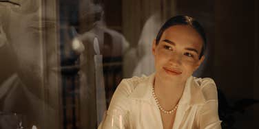 Woman smirking thinking about potential affair she denied
