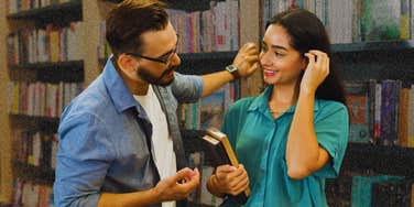 Man is powerfully magnetically attracted by a women in a book shop.