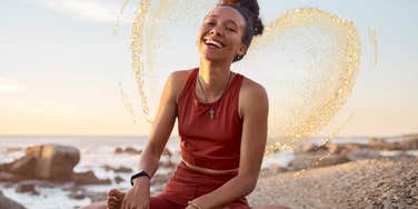Woman sitting on a beach, feeling great inner peace