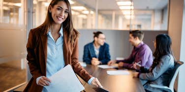 female employee in office with coworkers