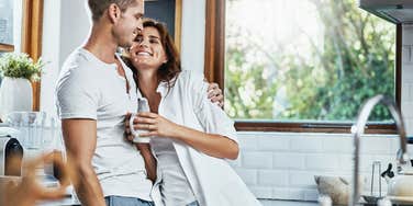 couple hugging in the kitchen
