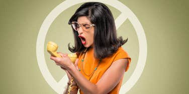 Woman yells into phone because she will never, ever compromise on certain things in her relationship.